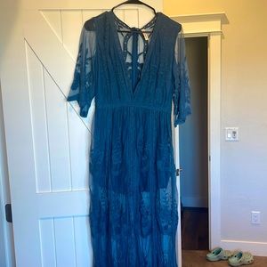 Turquoise romper. Size M. Purchased at Buckle. Never worn. Deep V. Floral detail